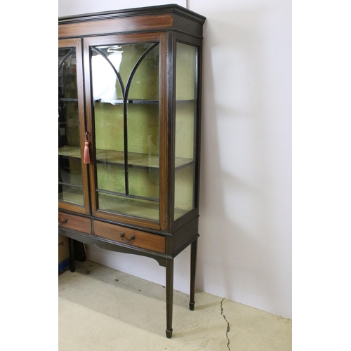 565 - Marquetry inlaid mahogany display cabinet with glazed doors and two short drawers, raised on square ... 