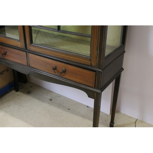 565 - Marquetry inlaid mahogany display cabinet with glazed doors and two short drawers, raised on square ... 