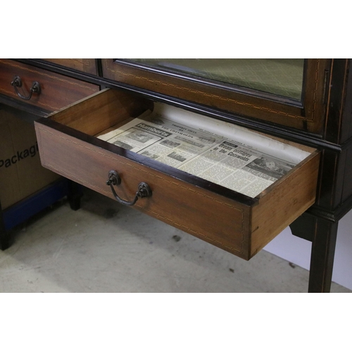 565 - Marquetry inlaid mahogany display cabinet with glazed doors and two short drawers, raised on square ... 