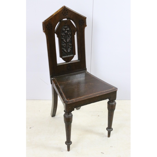 569 - Pair of Victorian oak hall chairs with moulded edge seat and carved back panel on turned legs, H 88c... 