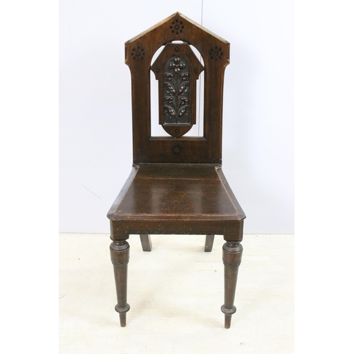 569 - Pair of Victorian oak hall chairs with moulded edge seat and carved back panel on turned legs, H 88c... 