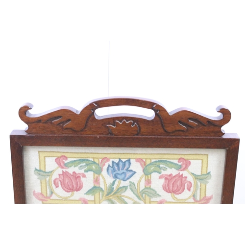 580 - Arts and crafts mahogany fire screen with glass screen and hand carved pediment housing a wool work ... 