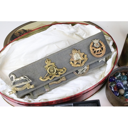 288 - Collection of mixed items to include brass cartridge case, souvenir belt with fourteen badges, Will'... 