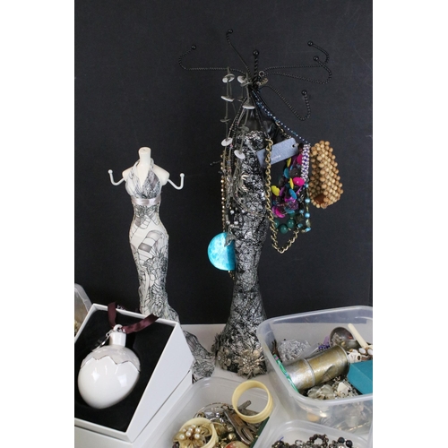 291 - Mixed assortment of costume jewellery items to include two jewellery stands in the form of women, be... 