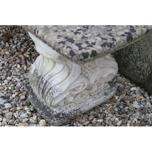 540 - Reconstituted stone bench with scroll base H 41cm, W 124cm, D 38cm