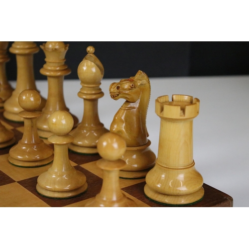 180 - A vintage Staunton chess set within wooden box together with wooden chess board. king stands approx ... 