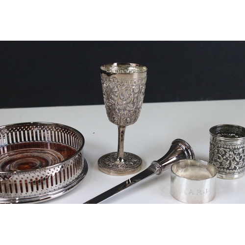 327 - Indian silver white metal goblet and drink measure cup, together with a silver plated wine coaster, ... 