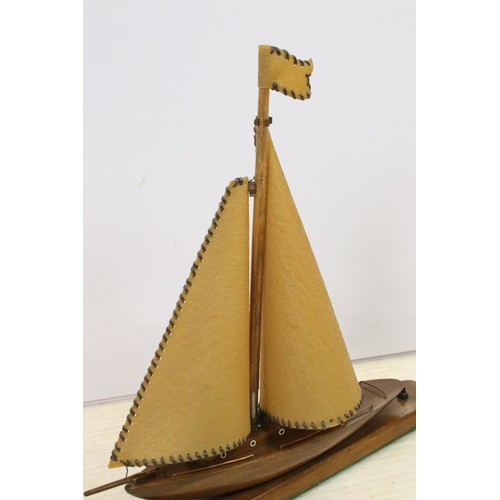 646 - Art Deco table lamp in the form of a boat of wooden construction with two hide sails and flag, measu... 