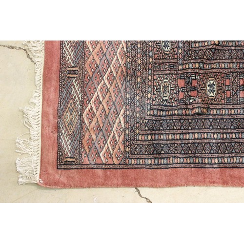 644 - Large Middle Eastern carpet rug having a red ground with medallions to central panel with blue and c... 