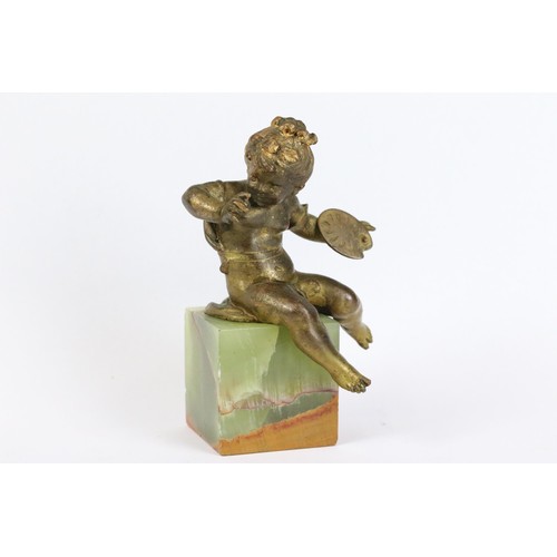 274 - Gilt metal figure of a putti holding an artist's palette, mounted to onyx base, 11.5cm high together... 