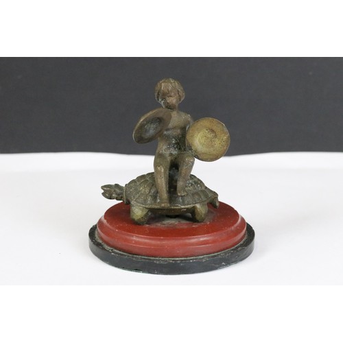 276 - Pair of 19th century gilt metal figures of putti playing drums whilst sitting in a tortoise, 6.5cm h... 