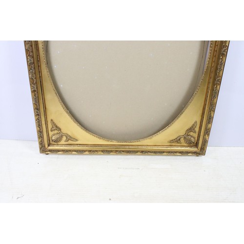 545 - 20th century gilt frame, oval inset within rectangular foliate border, 120 x 91.5cm