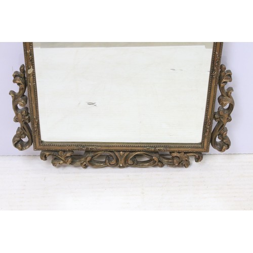 547 - Early 20th century gilt wall mirror with shell pediment above arched shaped bevelled glass within sc... 