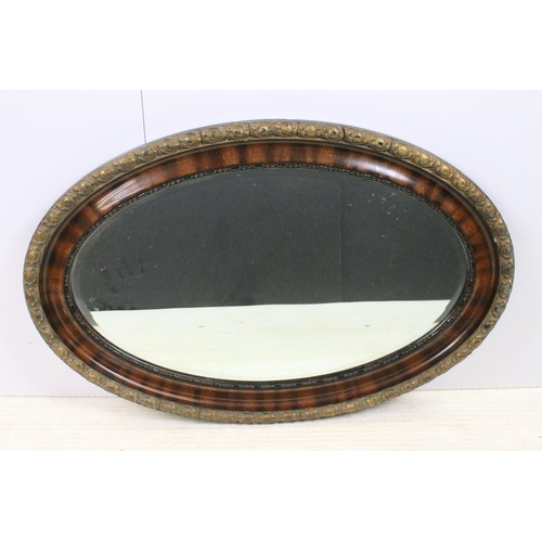 550 - Three mirrors to include an ornate oval gilt wood example together with oval oak frame mirror and ov... 