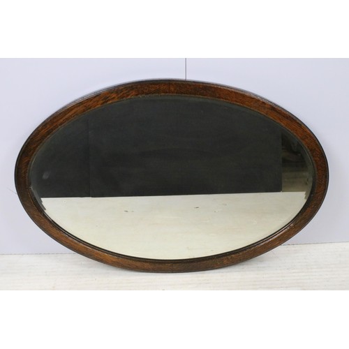 550 - Three mirrors to include an ornate oval gilt wood example together with oval oak frame mirror and ov... 