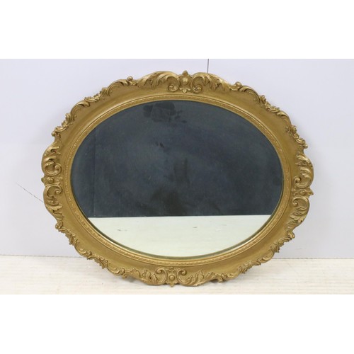 550 - Three mirrors to include an ornate oval gilt wood example together with oval oak frame mirror and ov... 