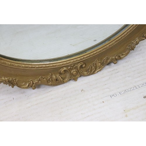 550 - Three mirrors to include an ornate oval gilt wood example together with oval oak frame mirror and ov... 