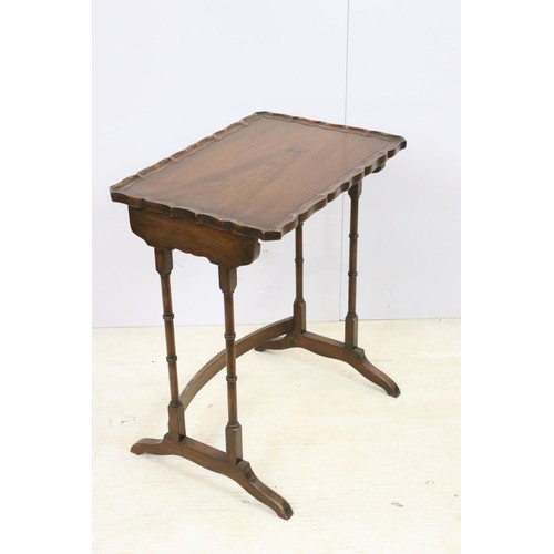 576 - 20th century mahogany nest of three tables with raised shaped edges above turnd legs and bowed suppo... 