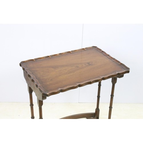 576 - 20th century mahogany nest of three tables with raised shaped edges above turnd legs and bowed suppo... 