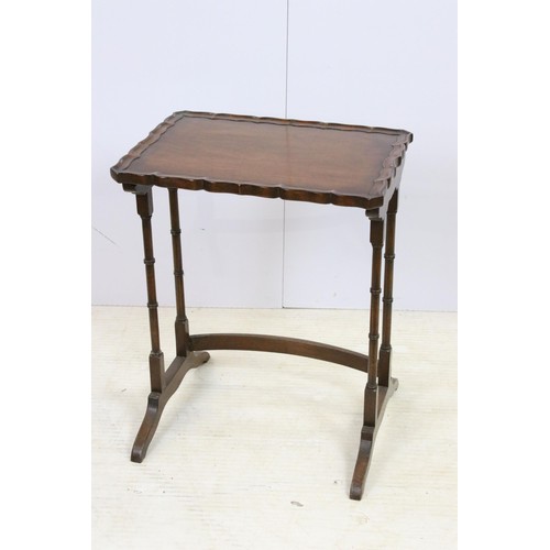 576 - 20th century mahogany nest of three tables with raised shaped edges above turnd legs and bowed suppo... 