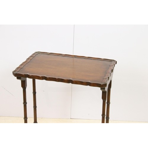 576 - 20th century mahogany nest of three tables with raised shaped edges above turnd legs and bowed suppo... 