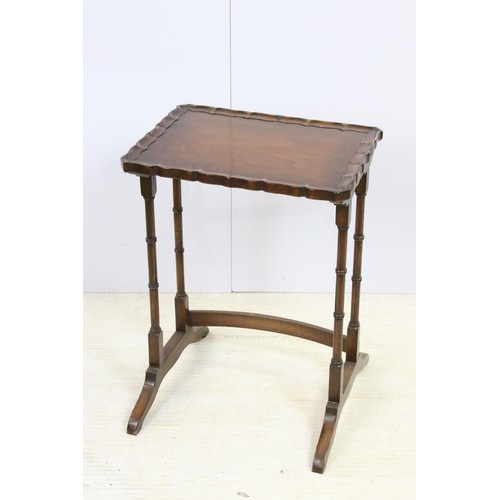 576 - 20th century mahogany nest of three tables with raised shaped edges above turnd legs and bowed suppo... 