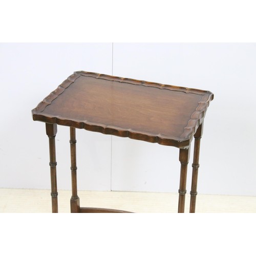 576 - 20th century mahogany nest of three tables with raised shaped edges above turnd legs and bowed suppo... 