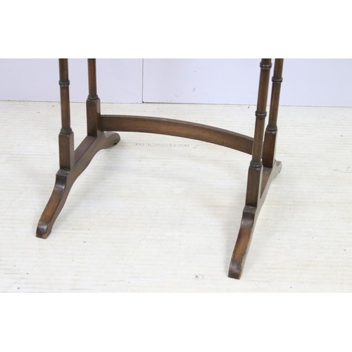 576 - 20th century mahogany nest of three tables with raised shaped edges above turnd legs and bowed suppo... 