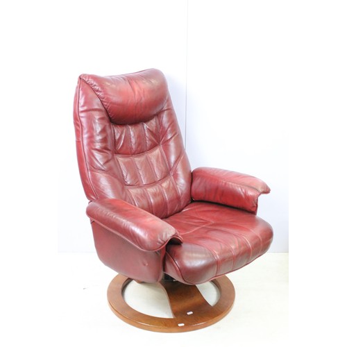 640 - Red leather reclining chair with matching footstool, the chair 102cm high x 80cm wide x 49cm deep