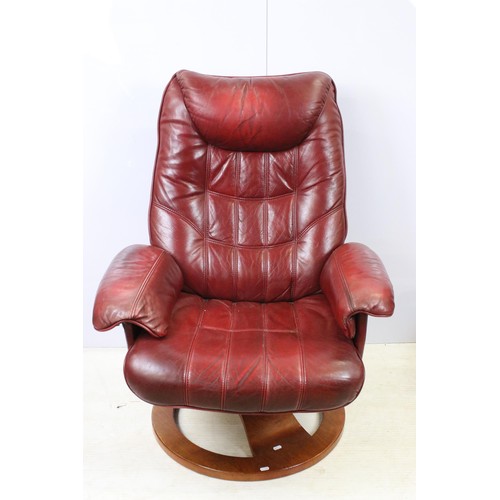 640 - Red leather reclining chair with matching footstool, the chair 102cm high x 80cm wide x 49cm deep