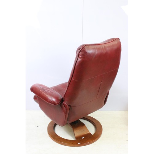 640 - Red leather reclining chair with matching footstool, the chair 102cm high x 80cm wide x 49cm deep