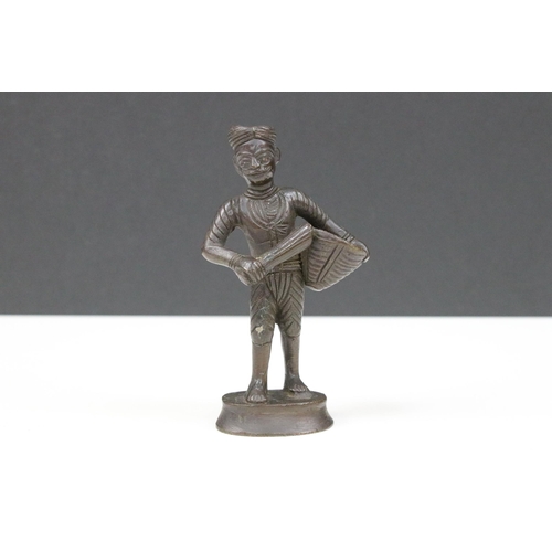 161A - Bronze figure of a south East Asian man carrying a basket, 12cm high