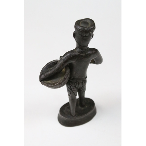 161A - Bronze figure of a south East Asian man carrying a basket, 12cm high