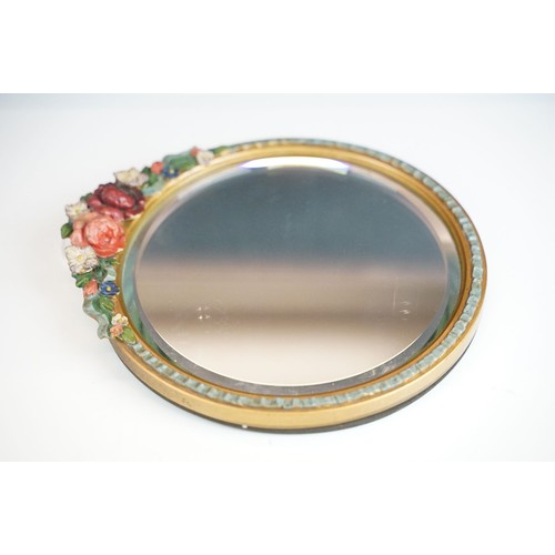 101A - Early 20th century barbola mirror, with circular bevelled glass, the pediment moulded with flowers, ... 