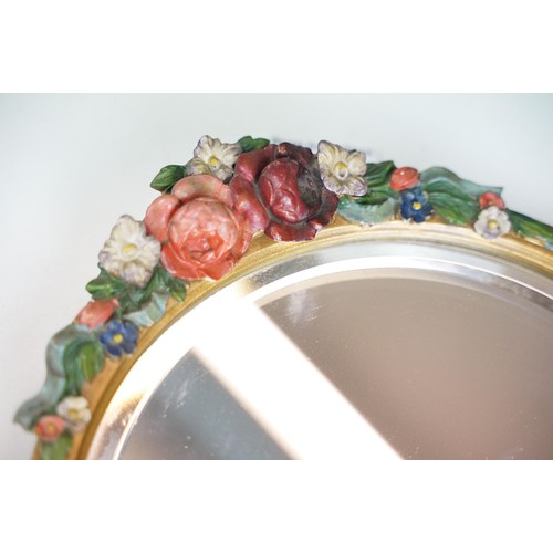 101A - Early 20th century barbola mirror, with circular bevelled glass, the pediment moulded with flowers, ... 