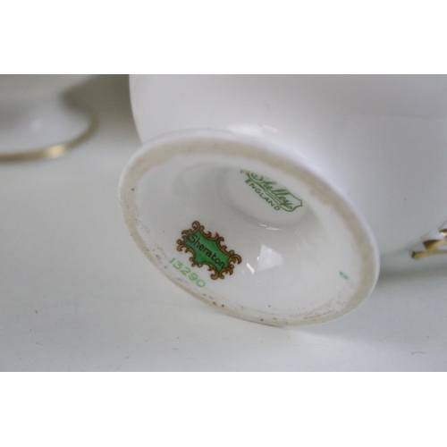 82 - Shelley green and floral tea set comprising of sugar bowl, milk jug, six tea cups and saucers, cake ... 