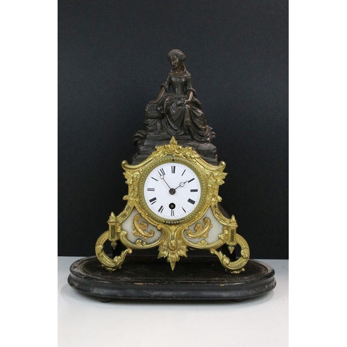 120 - 19th Century cast metal mantle clock with female figure and gil foliate details, the clock having a ... 