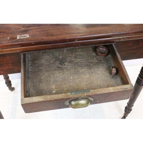 610 - 19th Century mahogany side table having a folding top with single drawer raised on turned legs with ... 