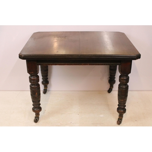 615 - 19th Century Victorian oak extending dining table having canted corners, turned legs and ceramic cas... 