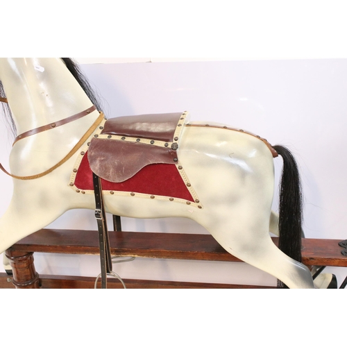 602 - Late 20th Century rocking horse with painted details, having a horse hair mane and tail, glass eyes ... 