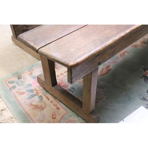 604 - Late 19th / early 20th Century oak station bench having a planked seat with pierced supports. Measur... 