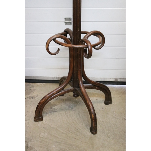 605 - Early 20th century bent wood coat stand with rotating top and stick stand to base. Measures 203cm ta... 