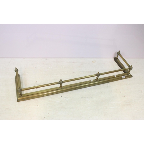 606 - 20th century brass fender fire surround together with small brass fire dogs and fireside set, approx... 