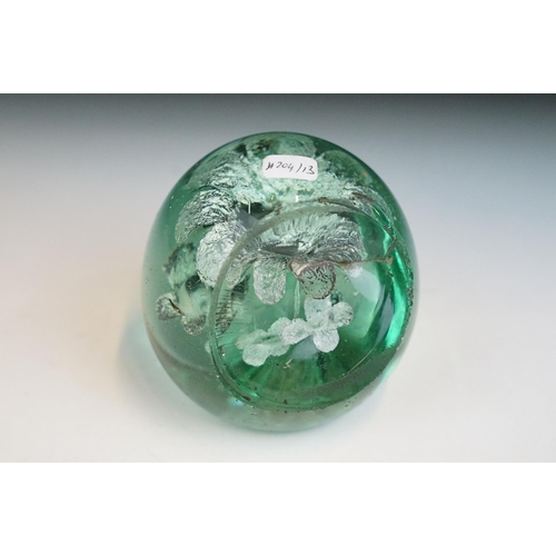 17 - Three Victorian hand blown green glass dump paperweights with interior flower and bubble patterns, t... 