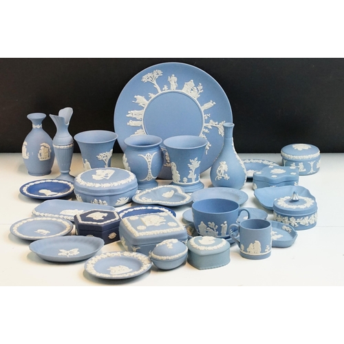 34 - Large selection of blue Wedgwood Jasperware pieces to include lidded boxes, vases, plates and trays,... 