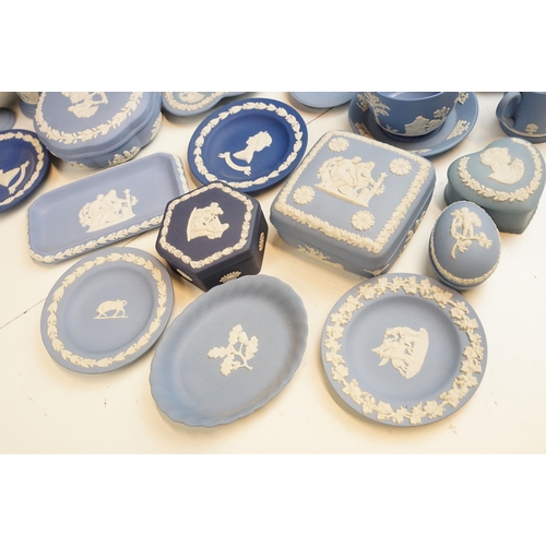 34 - Large selection of blue Wedgwood Jasperware pieces to include lidded boxes, vases, plates and trays,... 