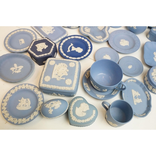 34 - Large selection of blue Wedgwood Jasperware pieces to include lidded boxes, vases, plates and trays,... 