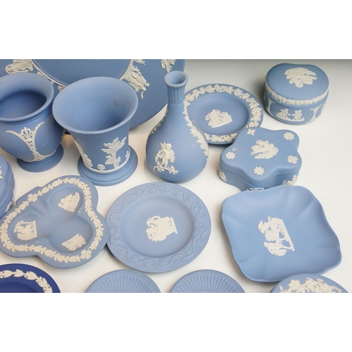 34 - Large selection of blue Wedgwood Jasperware pieces to include lidded boxes, vases, plates and trays,... 