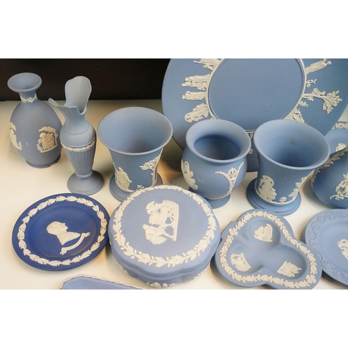 34 - Large selection of blue Wedgwood Jasperware pieces to include lidded boxes, vases, plates and trays,... 