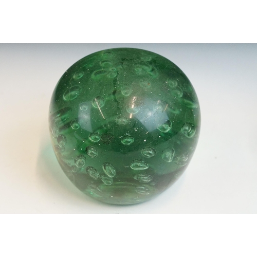 35 - Three hand blown green glass dump paperweights in varying sizes